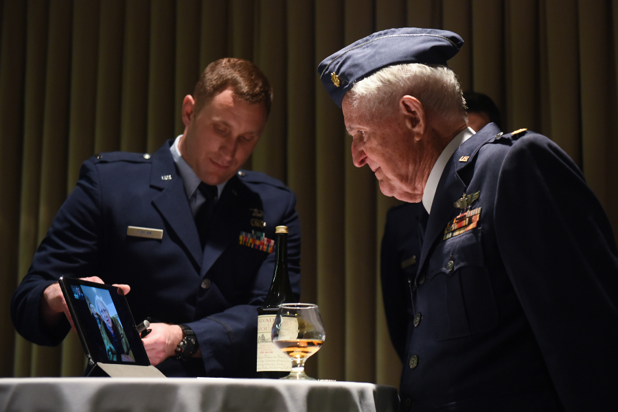 Maj. M. Eugene Johns and Col. Ralph Jenkins, WWII combat aviators and retired Air Force officers with the 510th Fighter Squadron, share a live-streamed greeting during a ceremony to toast their fallen Squadron members, Apr. 7, 2017, at Vandenberg Air Force Base, Calif. Personnel with the 510th FS made a pact that the last two surviving members of the unit who flew combat missions during WWII – Johns and Jenkins – would make a toast from two bottles of brandy which had been saved for the occasion.